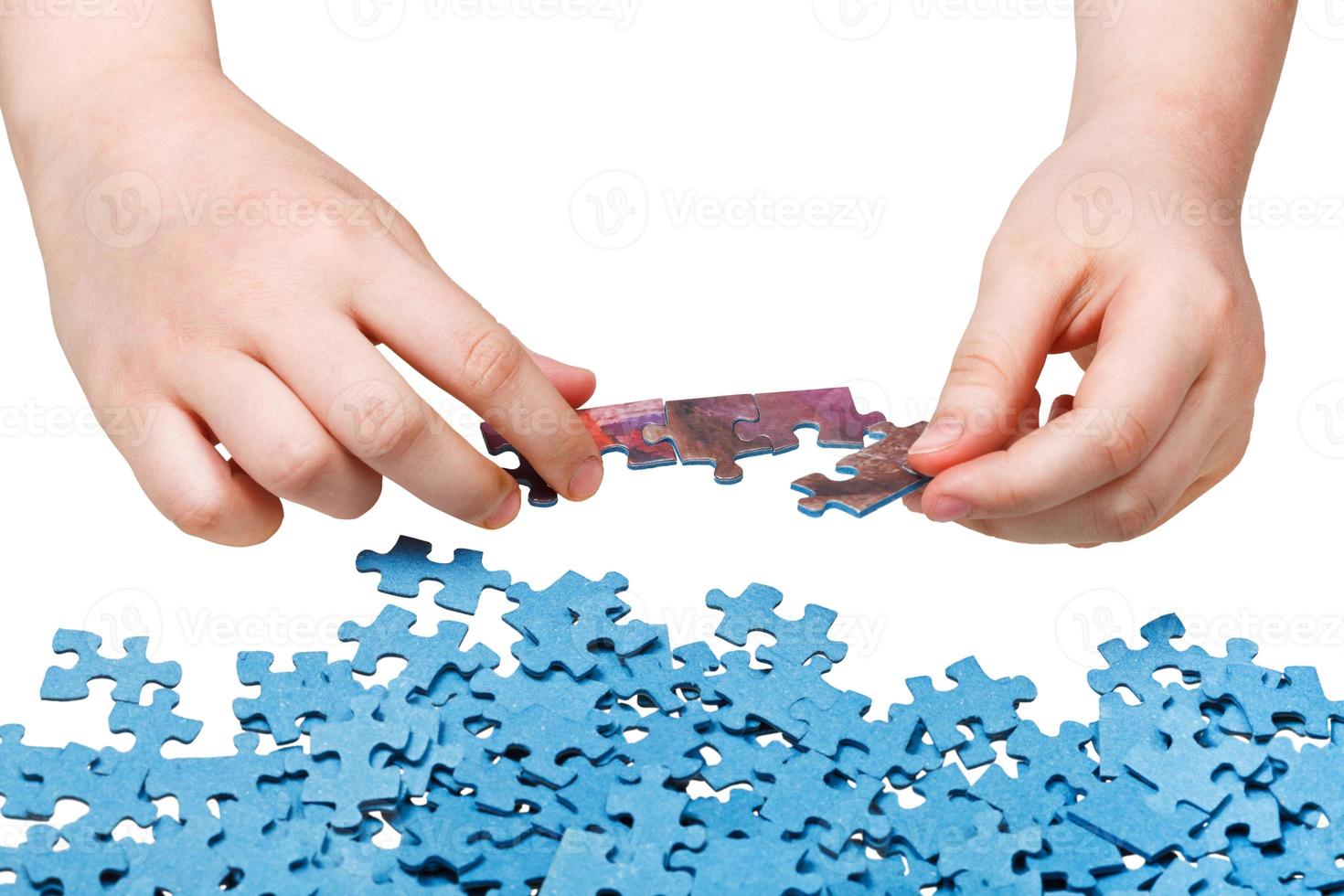 assembling of jigsaw puzzles isolated photo