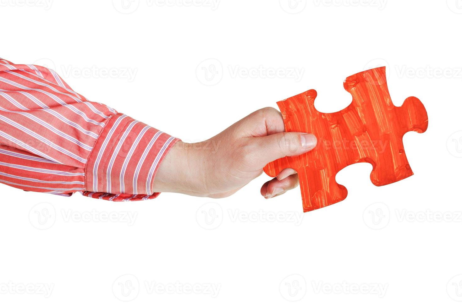 male hand with painted red puzzle piece photo