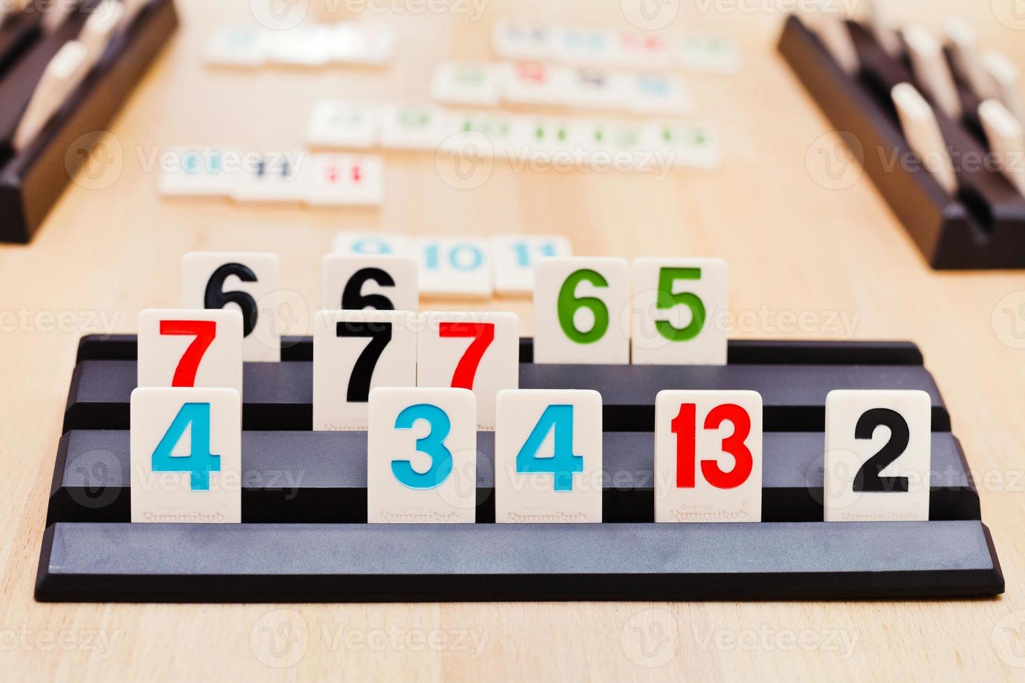 tile sets in playing rack of Rummikub board game photo