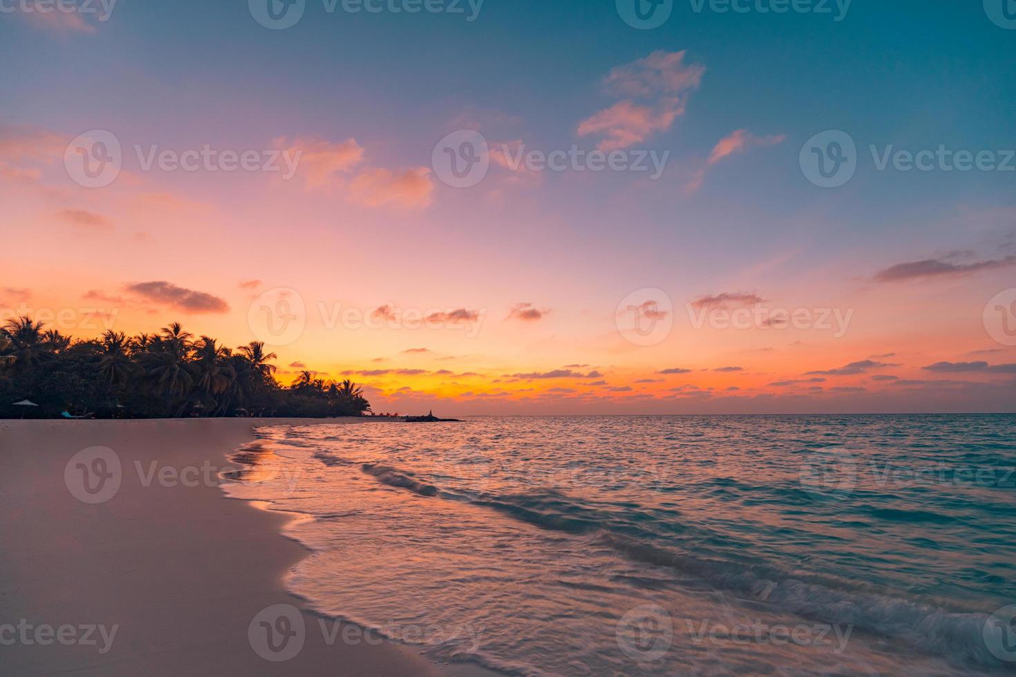 Sunset island beach. Paradise landscape beach. Tropical nature sea sand sky with palm tree forest silhouette and relaxing ocean water waves. Beautiful travel beach, sunrise over vacation destination photo