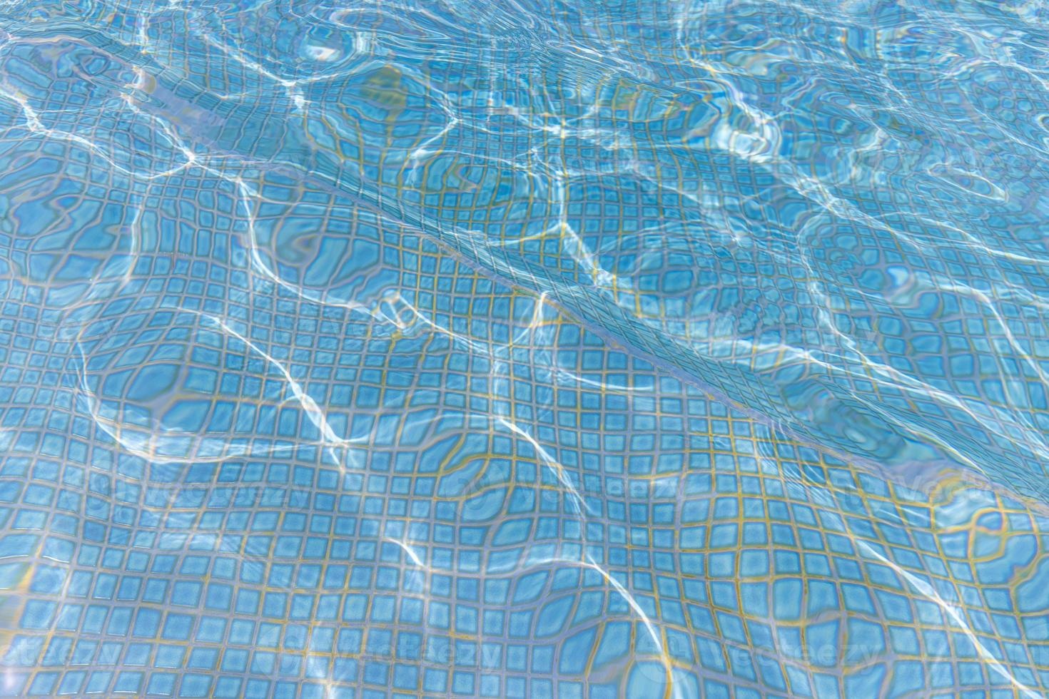 Beautiful clear blue water with waves and rays in the sea. Summer vacation and pool. Swimming pool, summer outdoor sport, recreational activity background concept photo