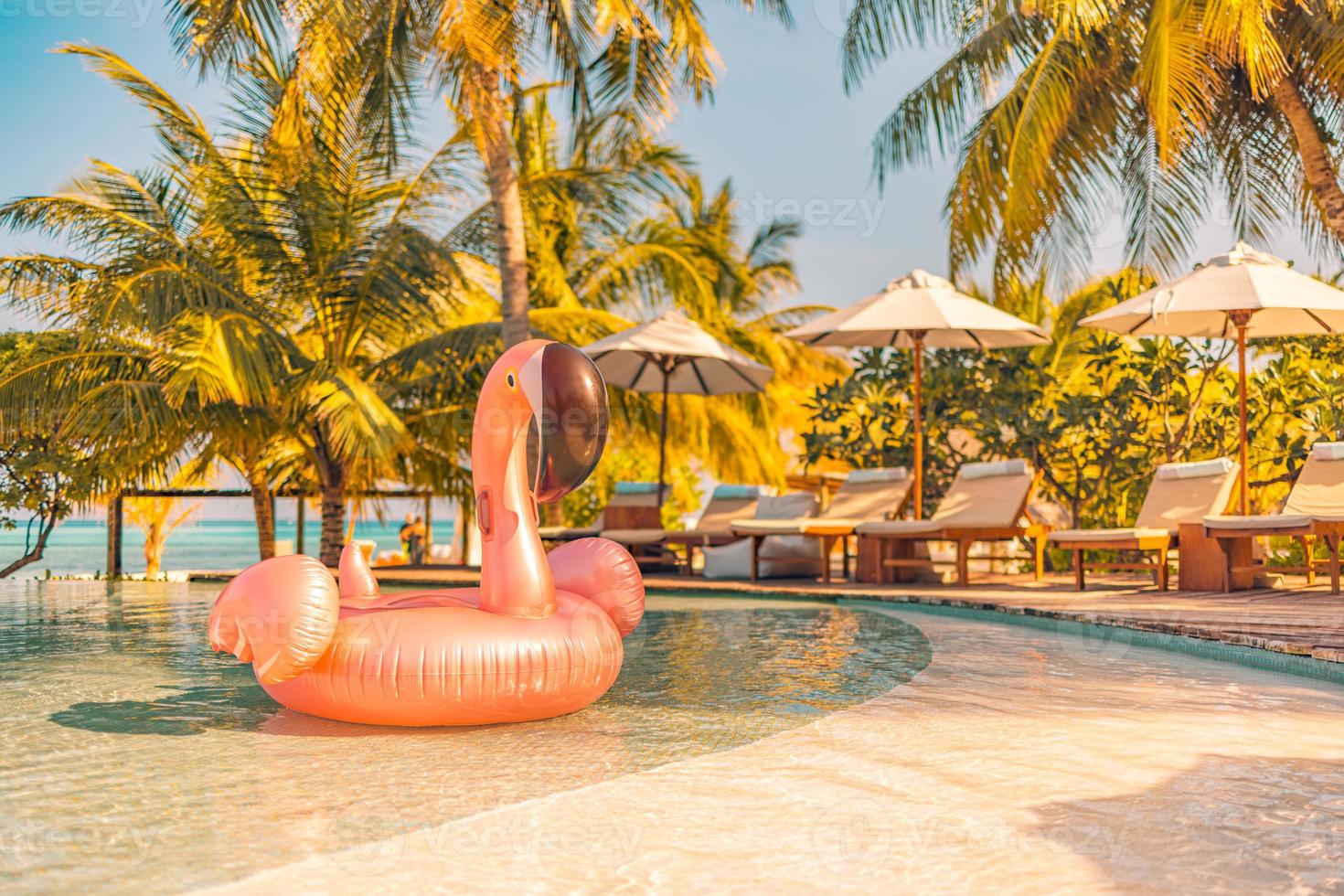 Summer tourism swimming pool inflatable pink flamingo, luxury resort hotel poolside. Happy sunset tropical paradise island infinity pool sea view. Vacation, holiday fun landscape. Relax leisure photo