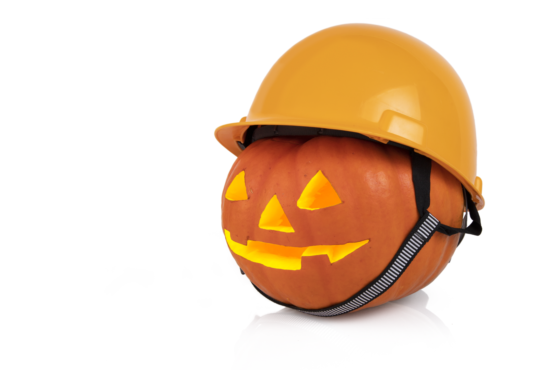 Orange pumpkin with glowing eyes in a yellow construction helmet, hard hat. Halloween concept