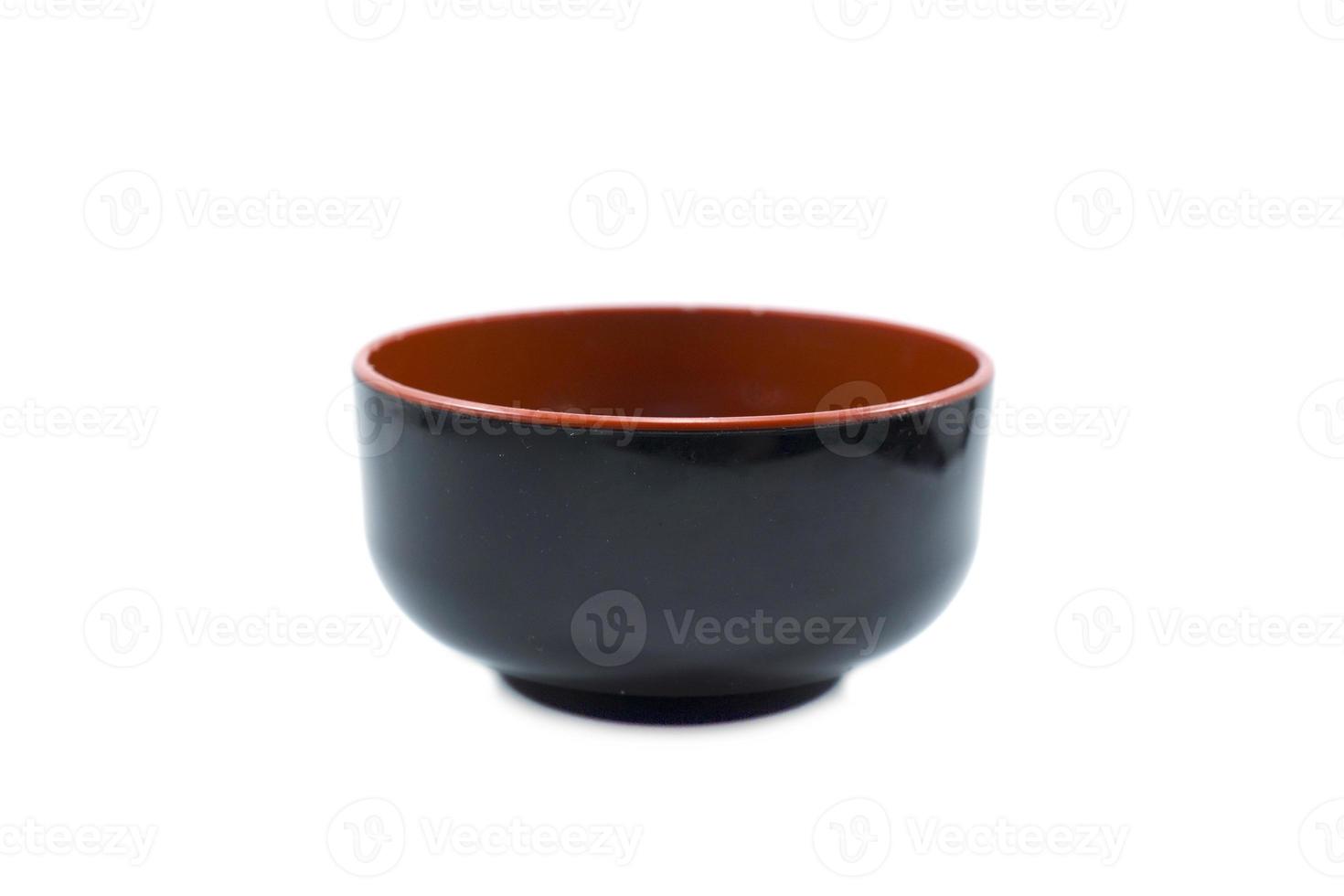 empty black plastic bowl with red inside isolated on white photo