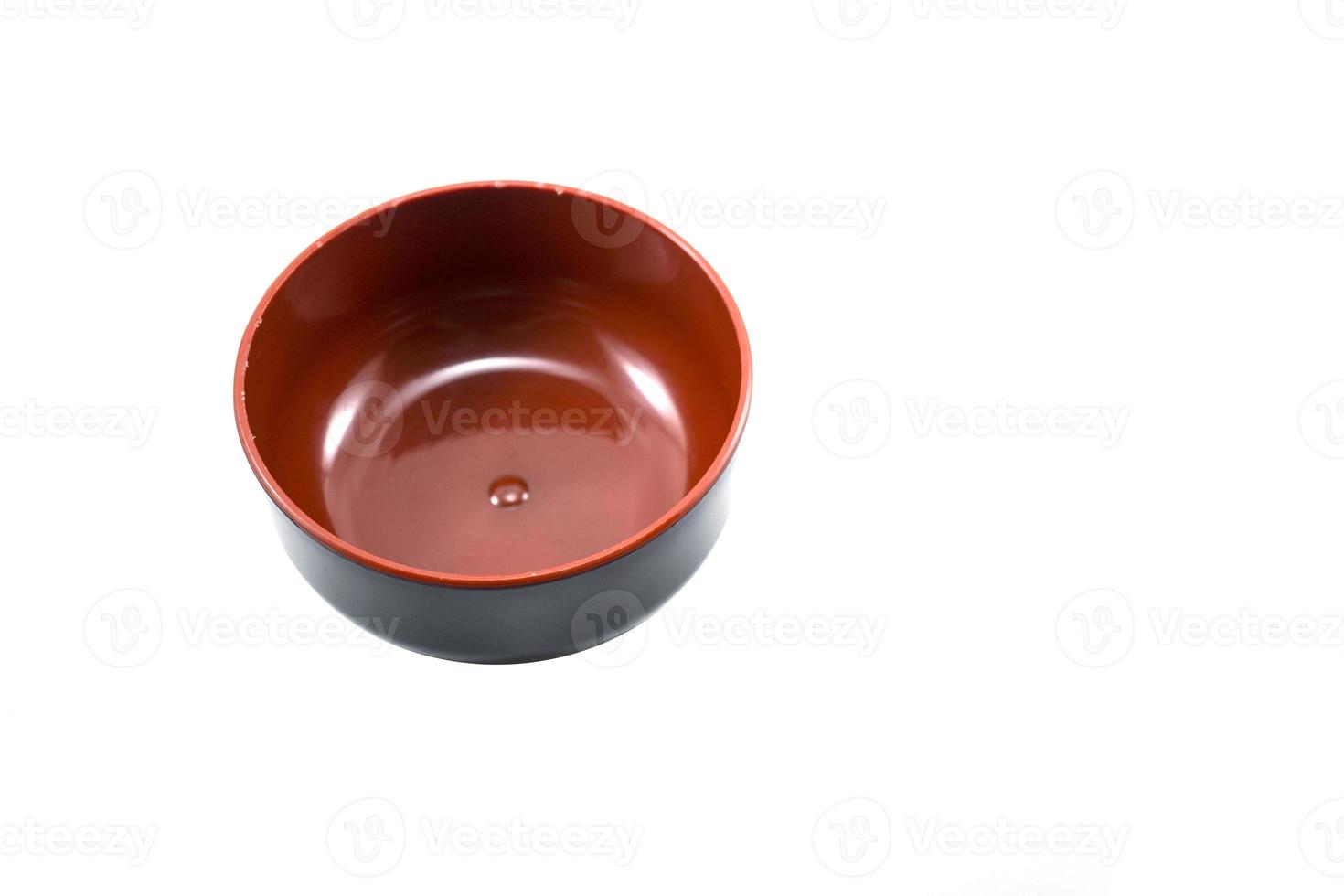 empty black plastic bowl with red inside isolated on white photo