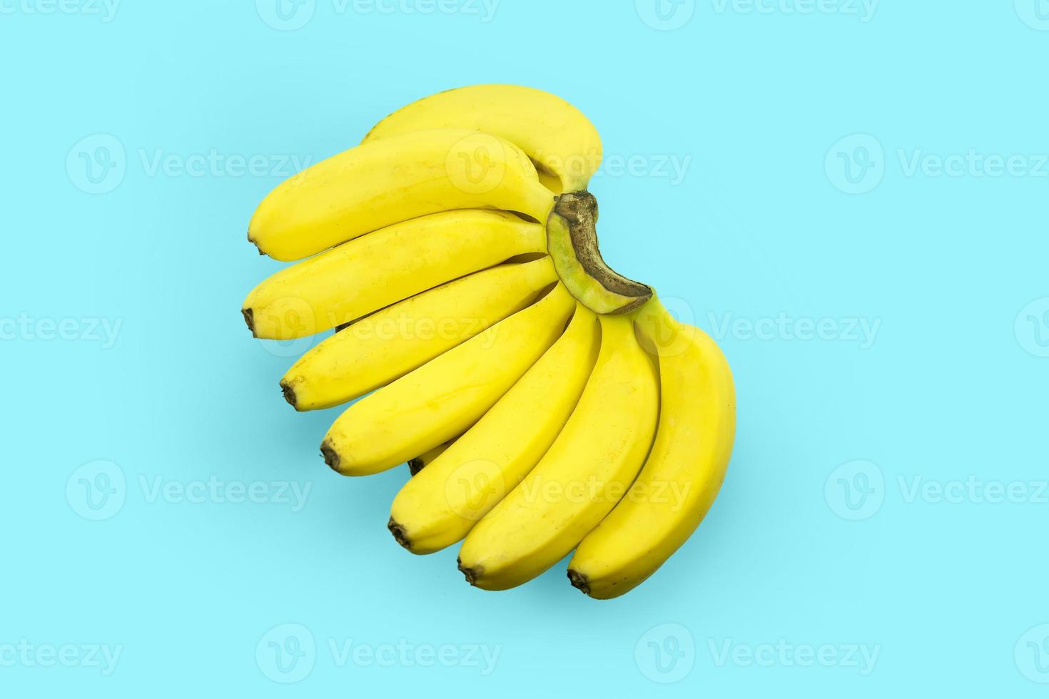 bunch of organic cavendish bananas isolated on a tosca photo