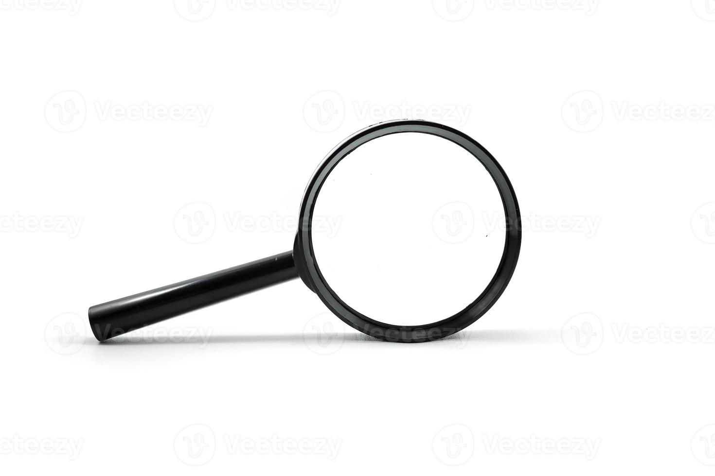 Close up single magnifying glass isolated on a white photo