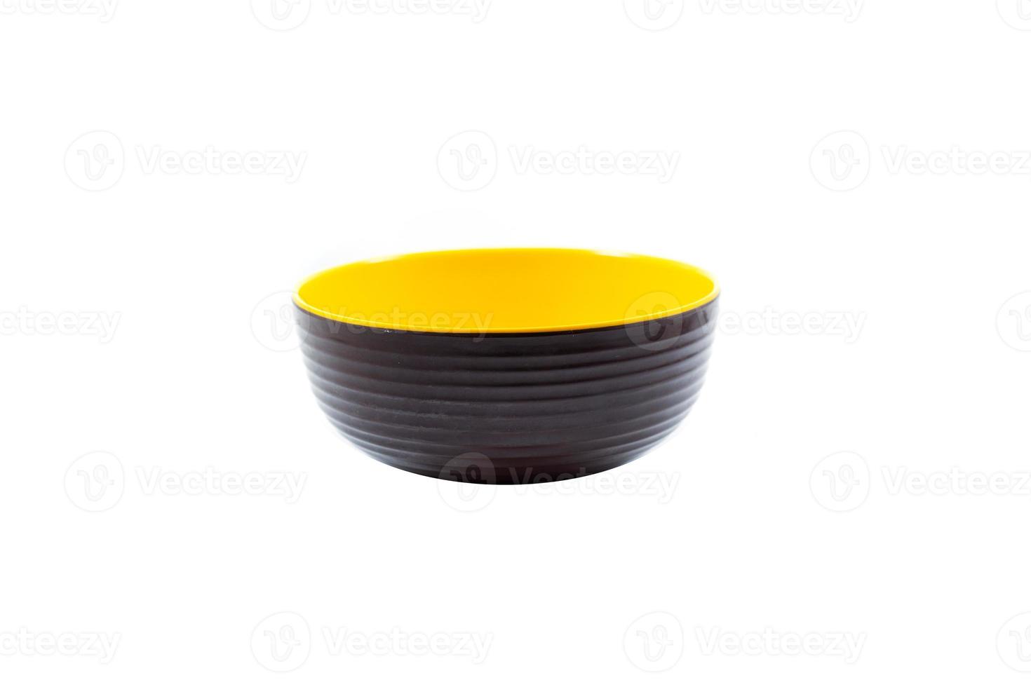 empty brown plastic bowl with yellow inside isolated on white photo