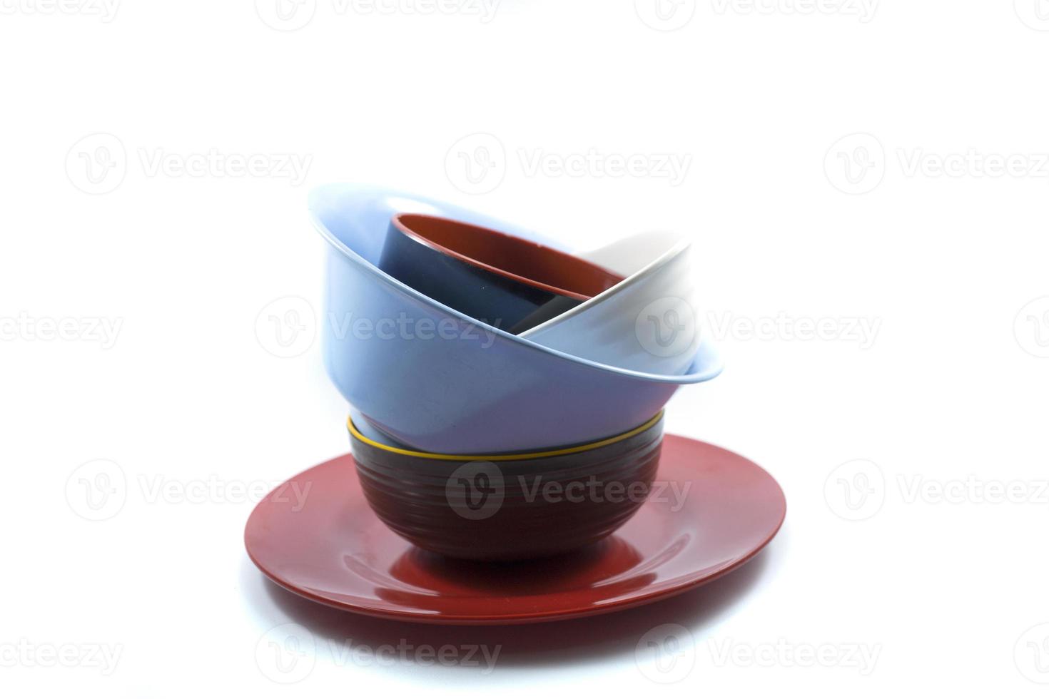 stack of empty plates and bowls isolated on a white photo
