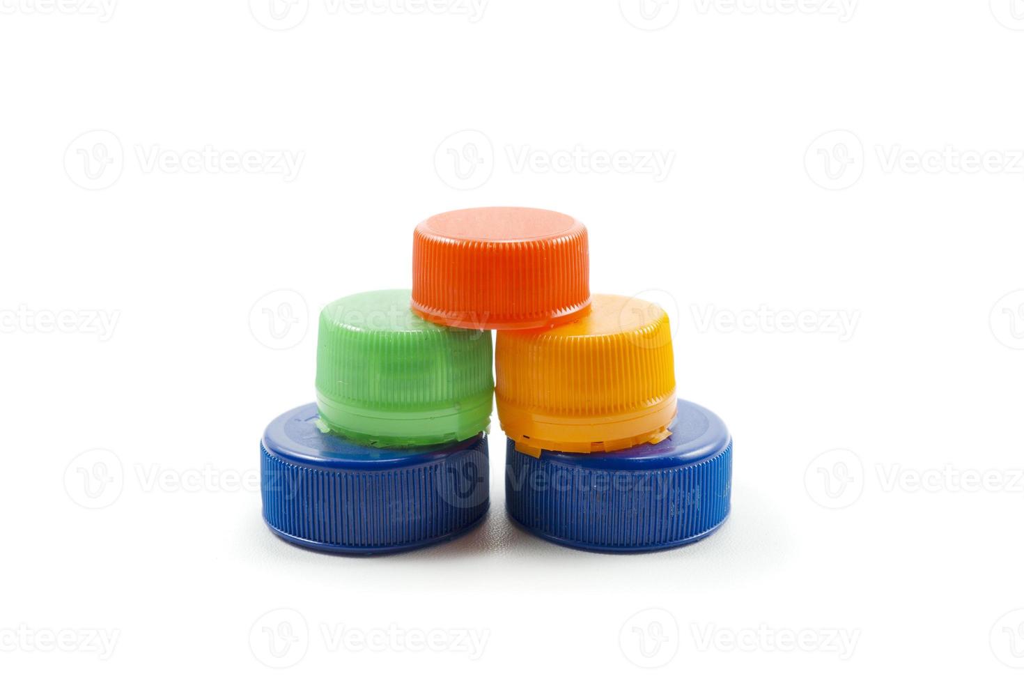 Colorful plastic bottle caps including recyclable materials isolated on a white photo