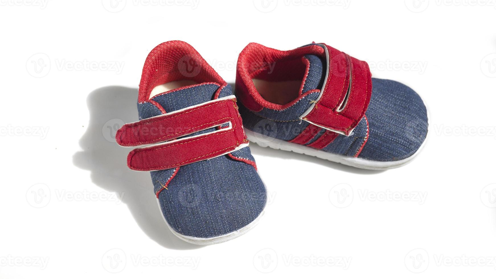 Baby jeans patterned and red shoes isolated on a white background photo