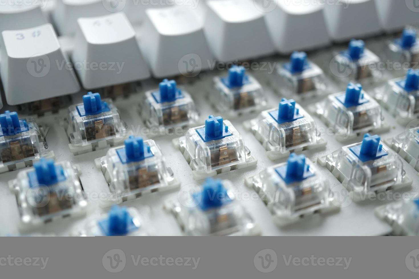 narrow depth of blue switch with disassembled mechanical keyboard game. photo