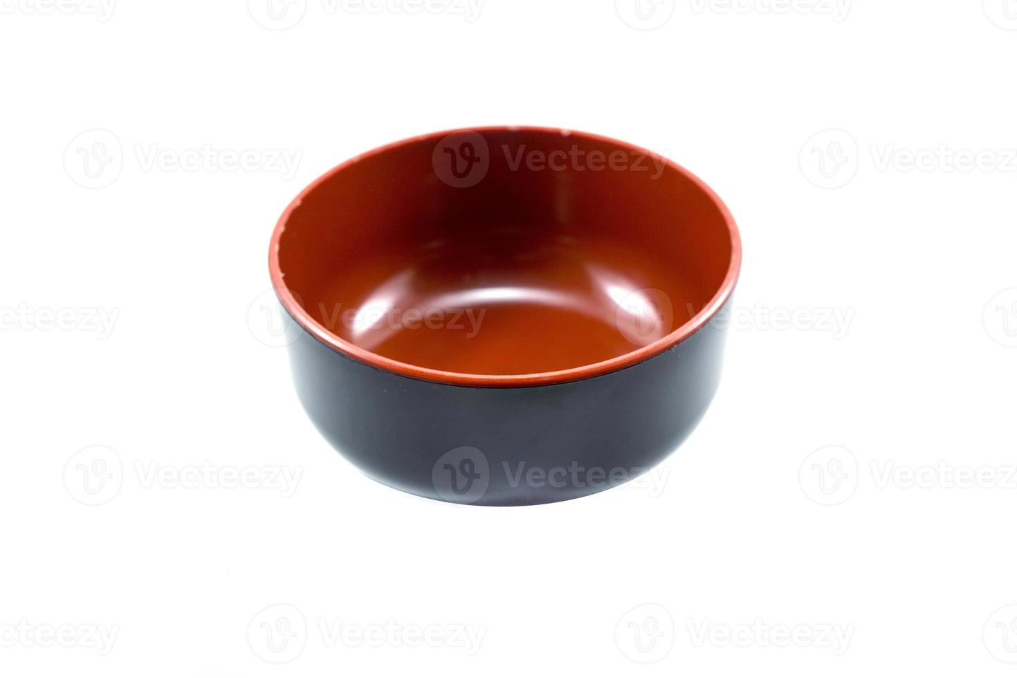 empty black plastic bowl with red inside isolated on white photo