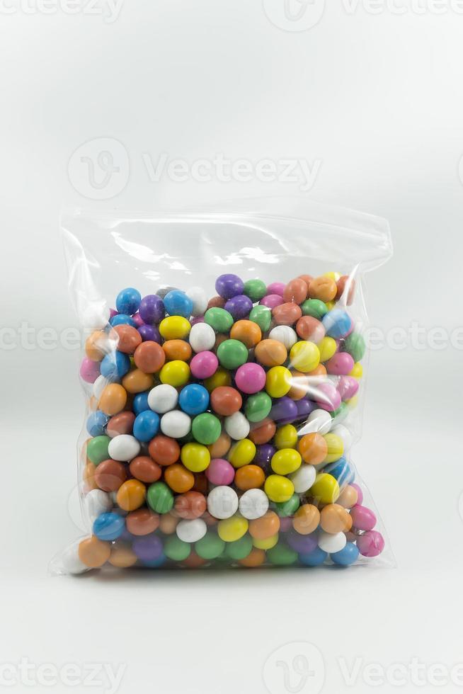 colorful milk chocolate candy shell packaged in plastic isolated on a white photo