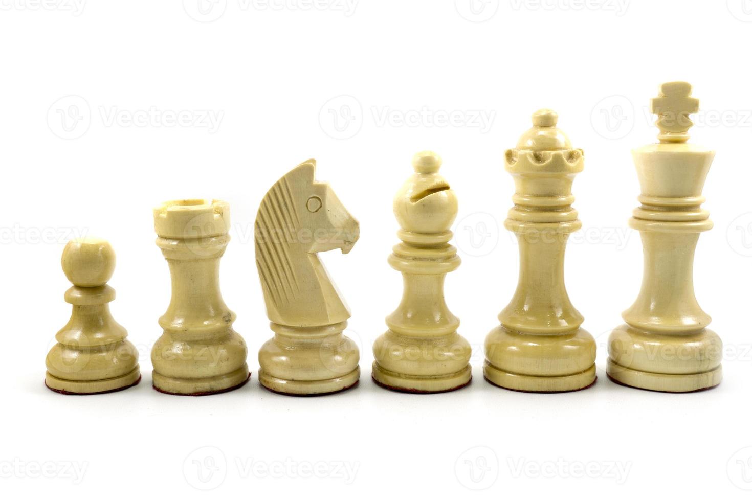 White chess pieces made of wood in descending order isolated on white photo
