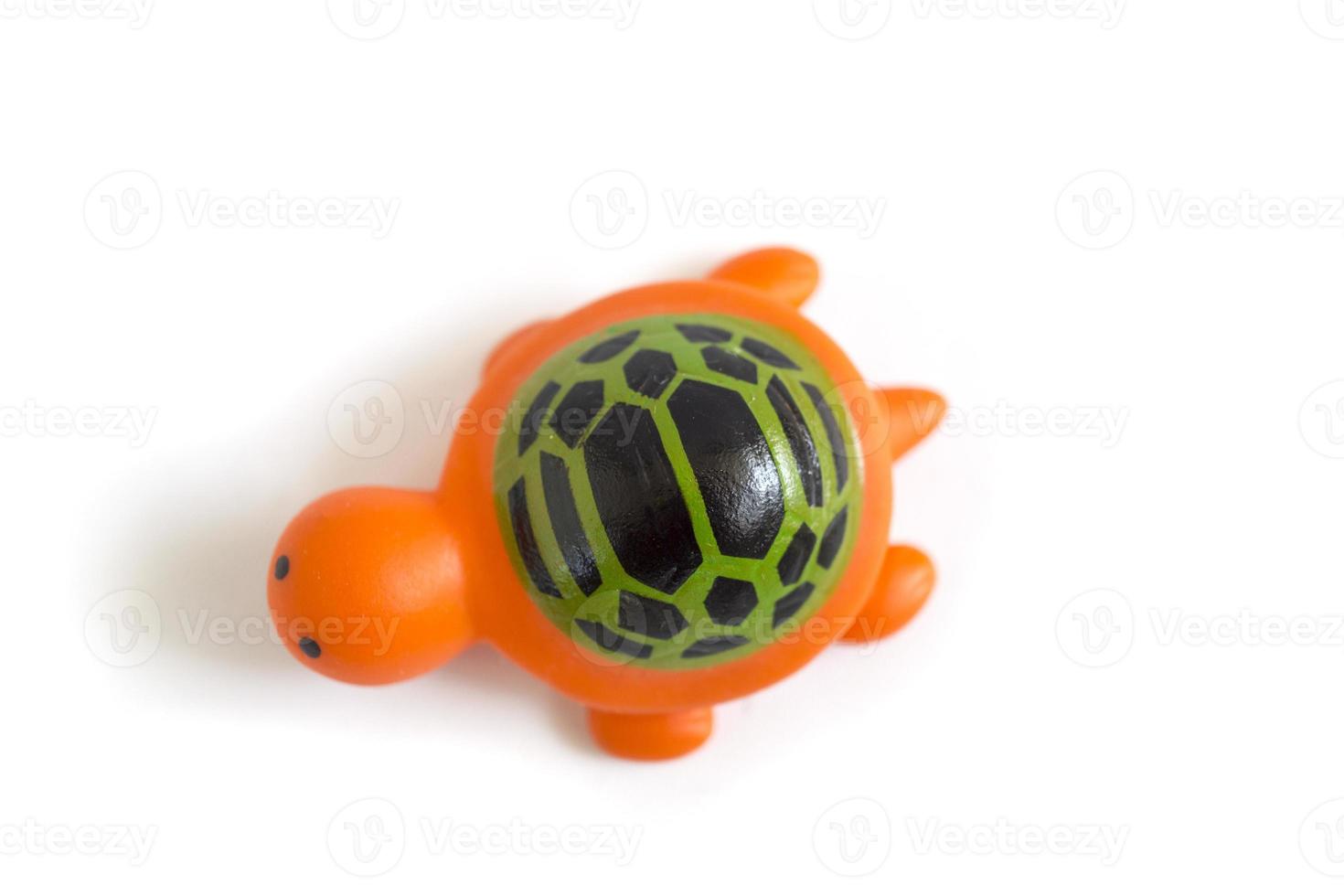 toddler toy orange rubber turtle used to play when bathing isolated on a white photo