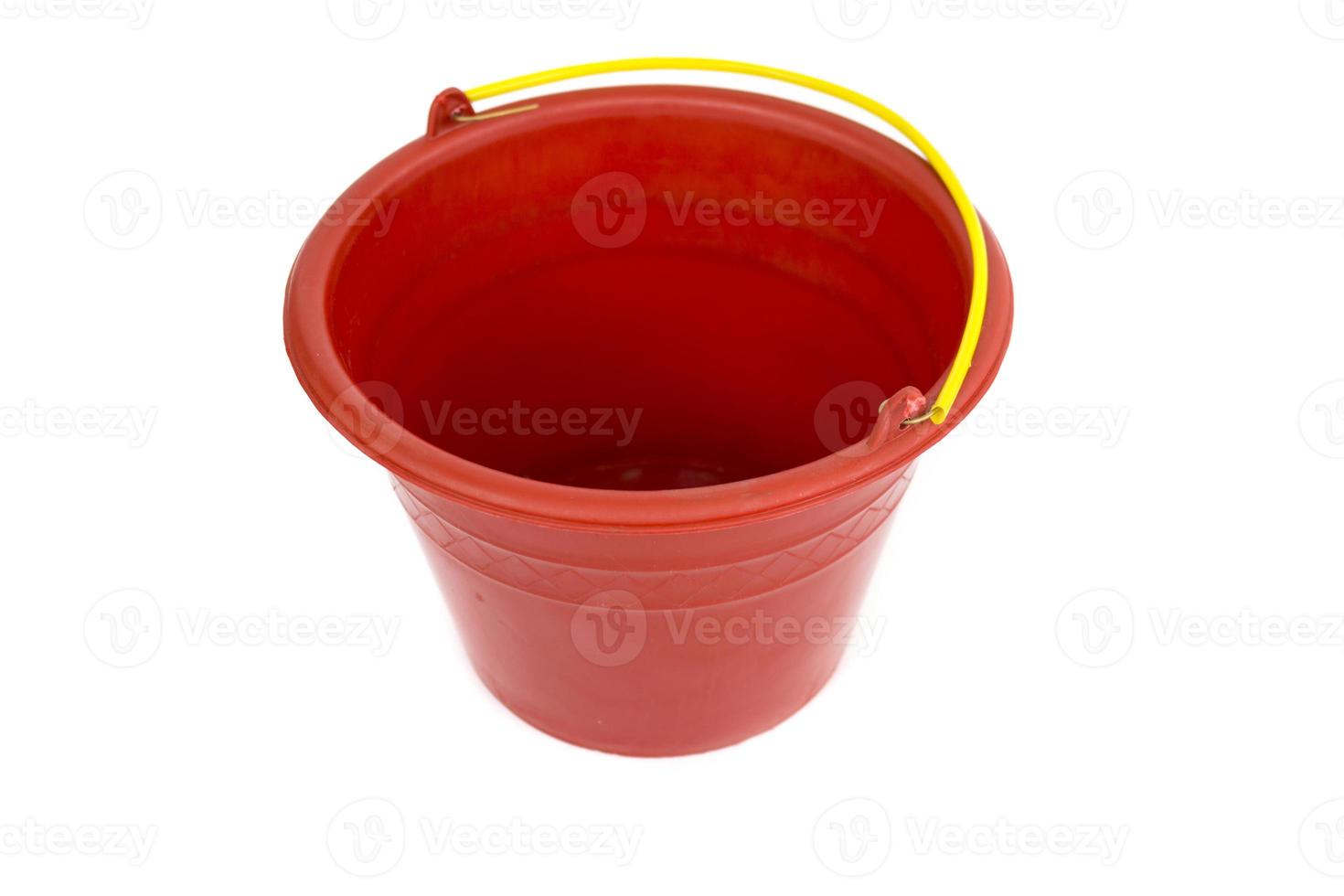 Red plastic bucket with yellow handle isolated on white background. photo