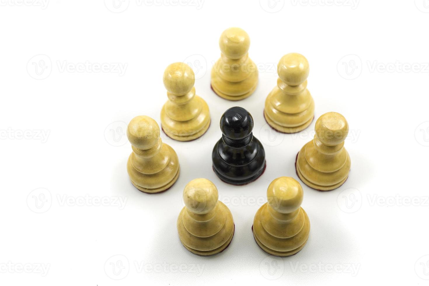 a group of white chess pawns make a circle in the middle there is a black photo