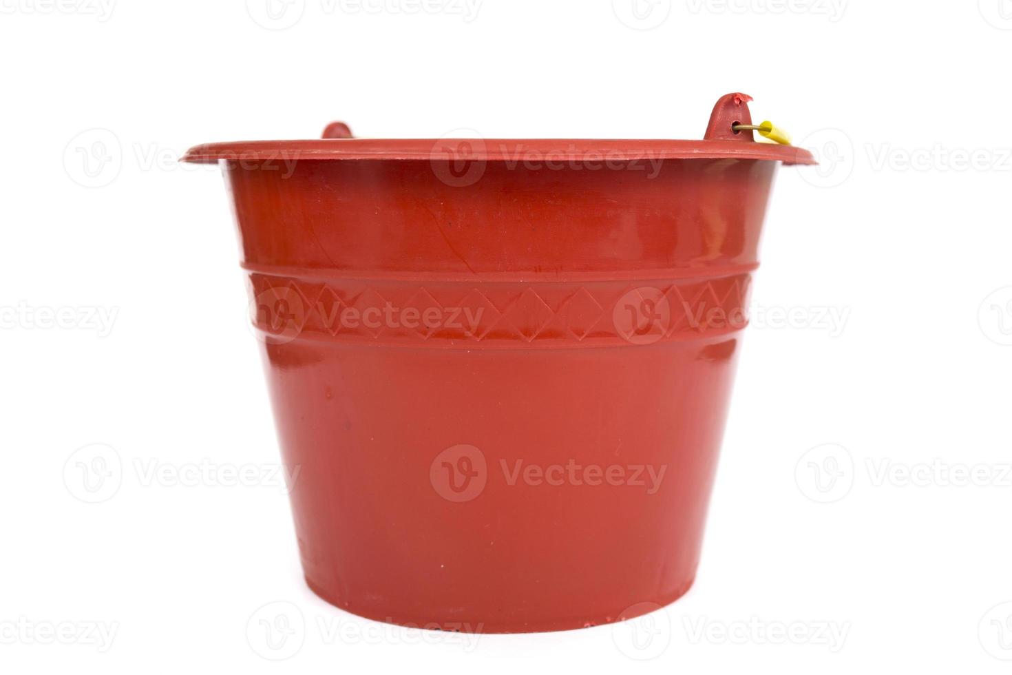 Red plastic bucket with yellow handle isolated on white background. photo