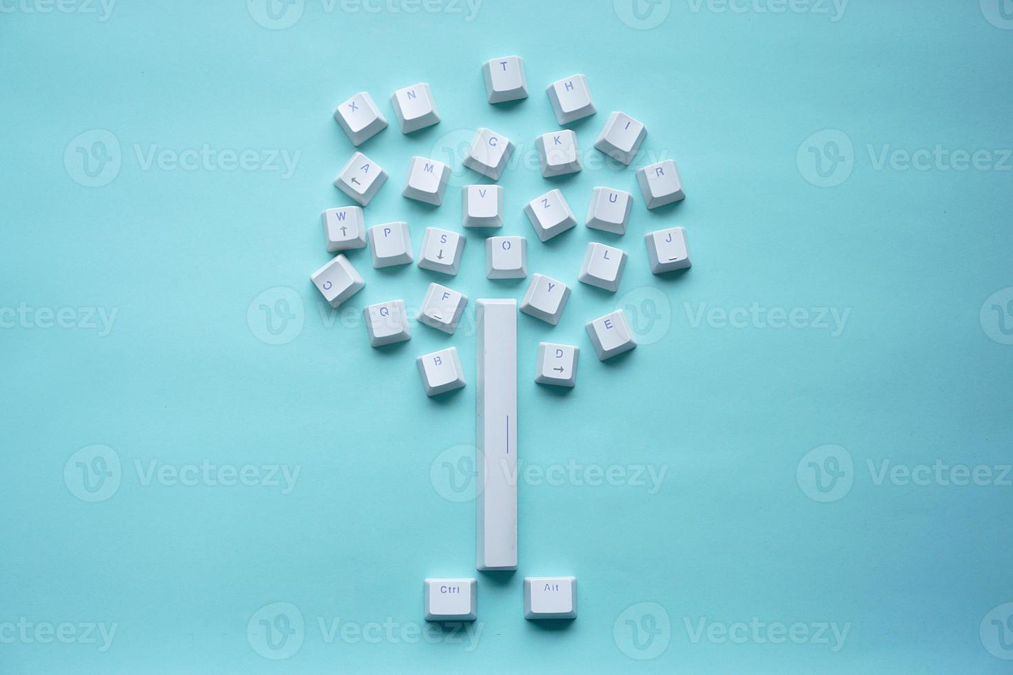 keyboard keys shaped like a tree isolated on a turquoise photo