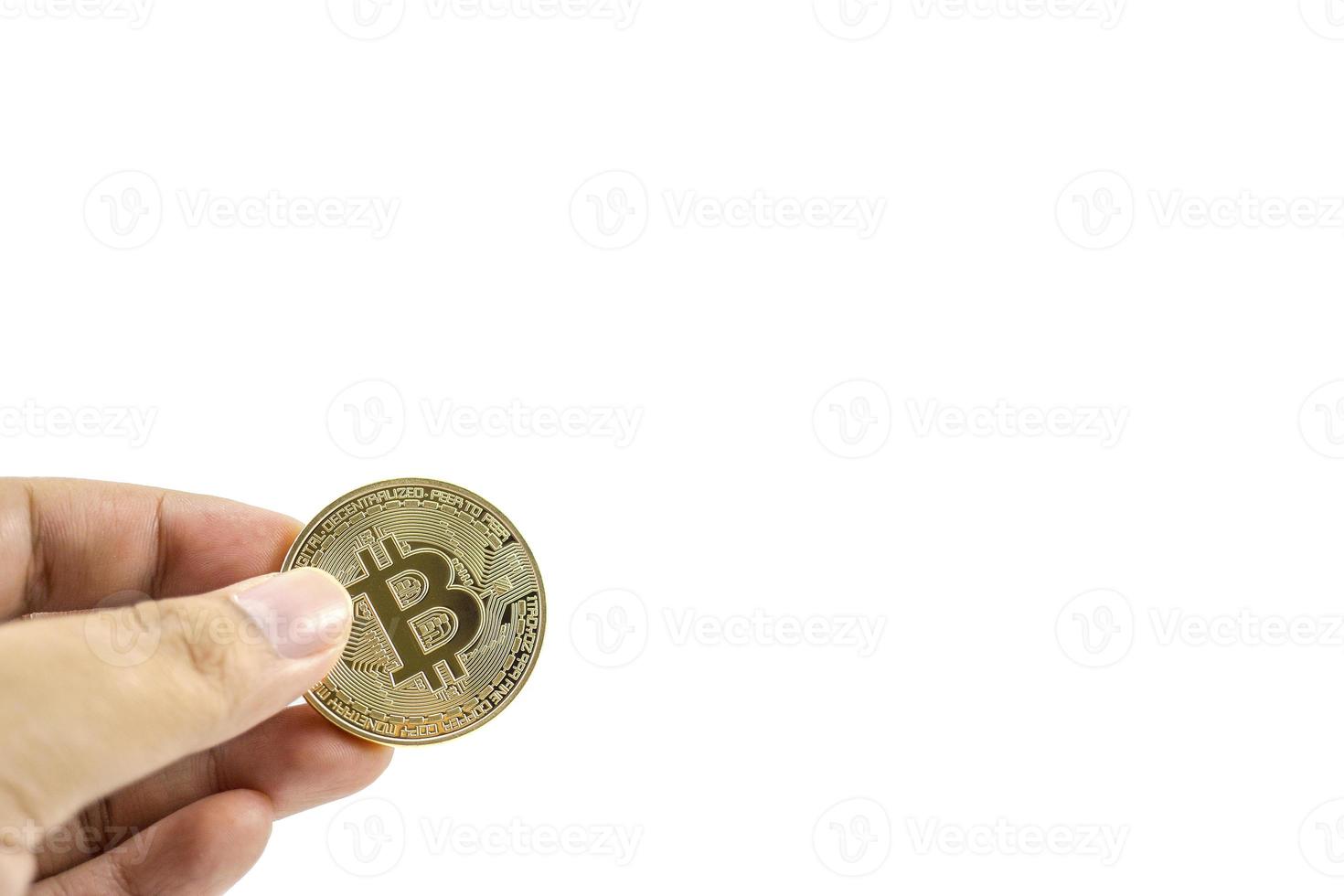 gold bitcoin coin in hand isolated on white background. photo