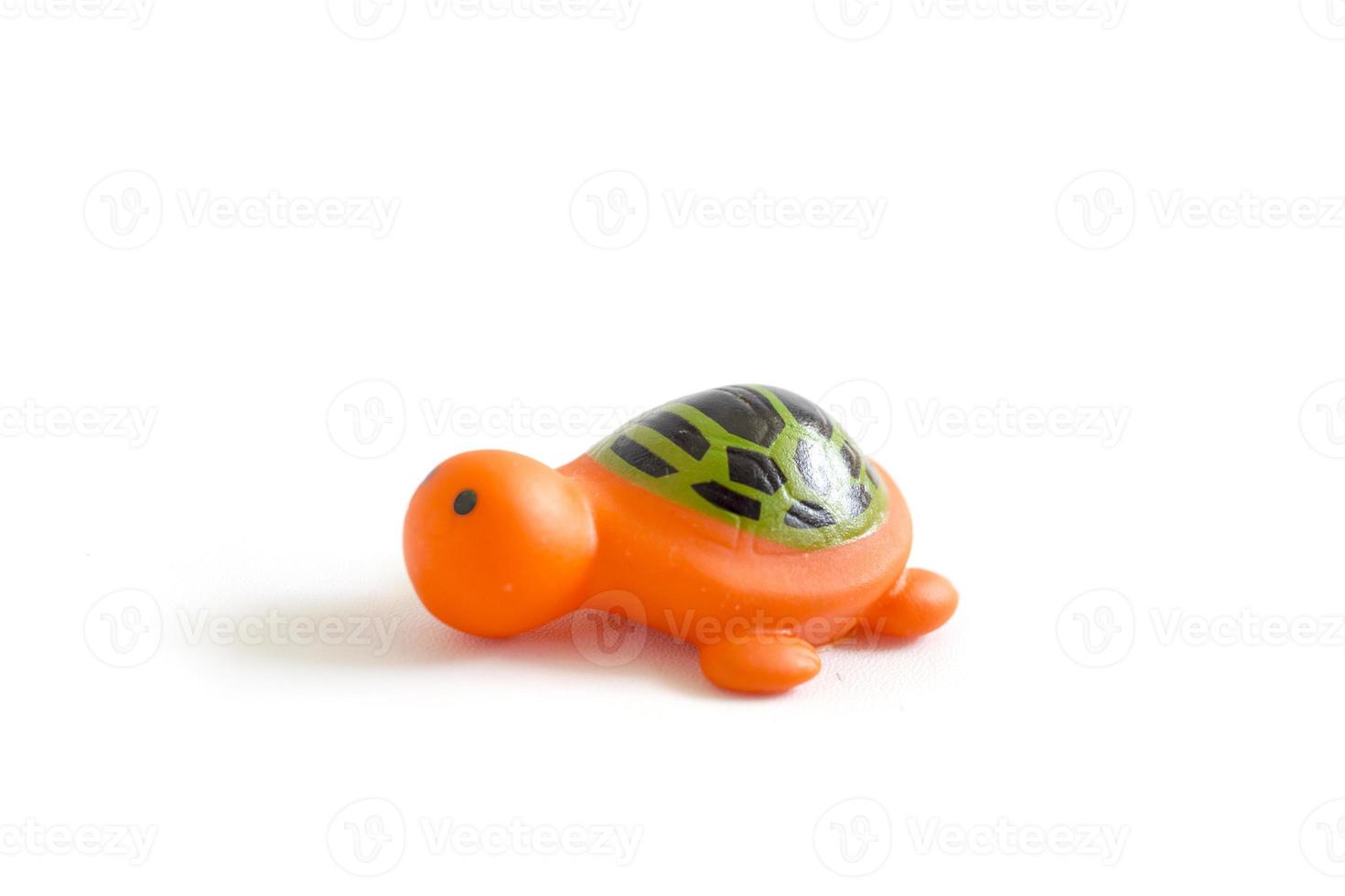toddler toy orange rubber turtle used to play when bathing isolated on a white photo