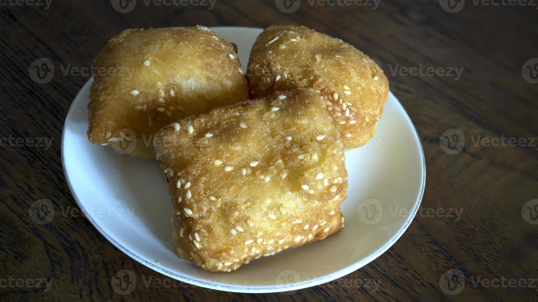 bolang baling cube-shaped fried bread sprinkled with sesame seeds photo