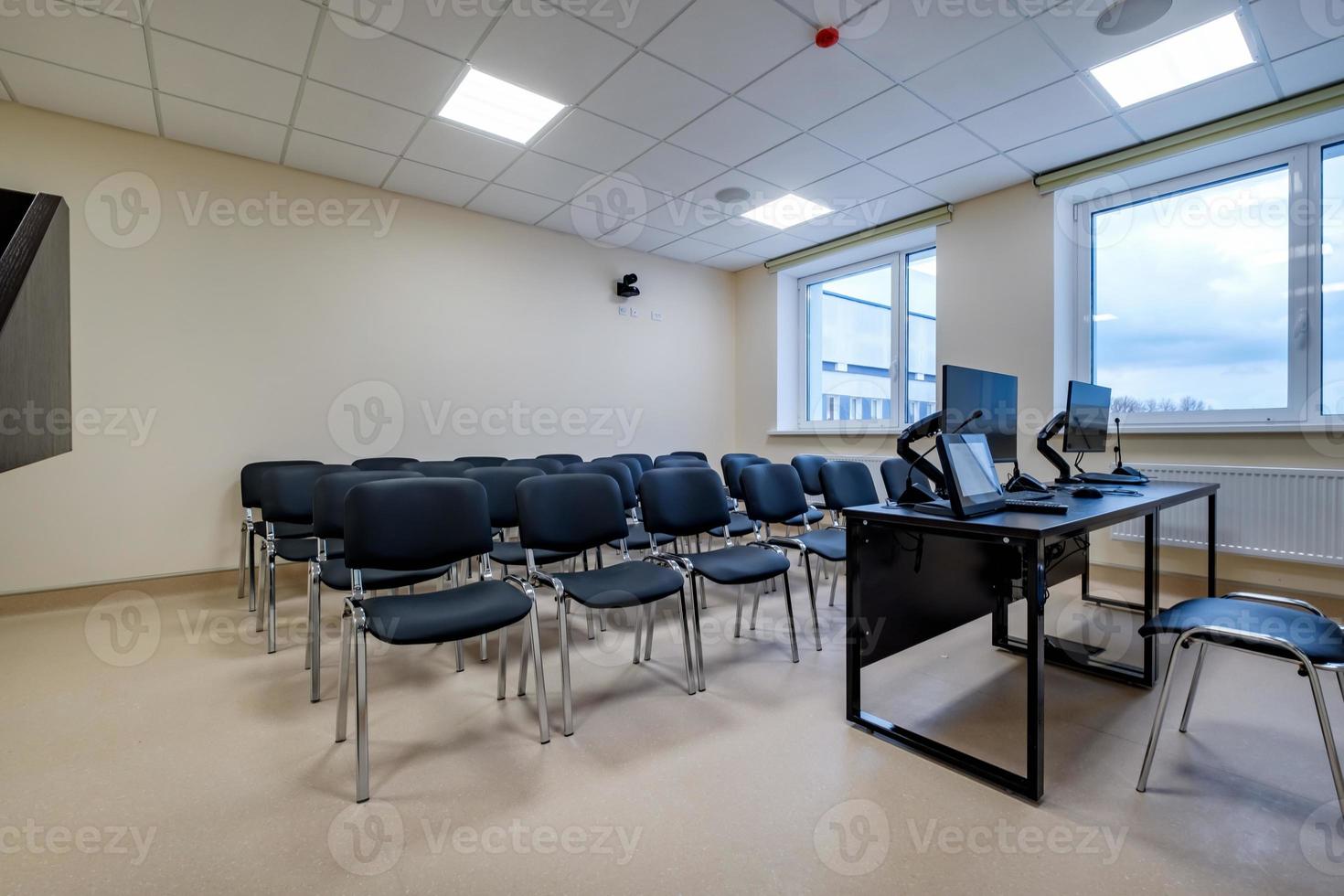 rows of seats in interior of modern empty conference hall for business meetings photo