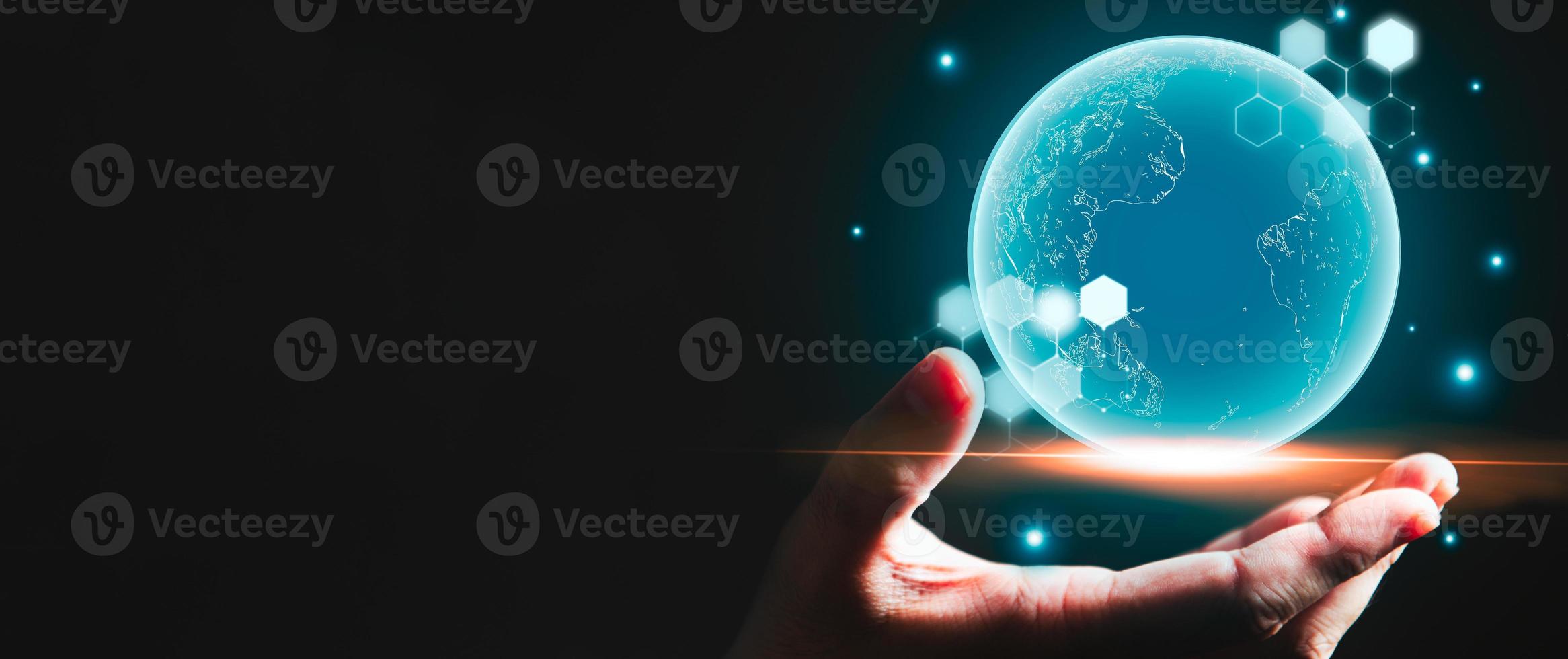 Businessman hand holding blue glowing earth hologram with copy space black background. Business and technology concept. Modern tech and metaverse theme. People and futuristic worldwide innovation photo