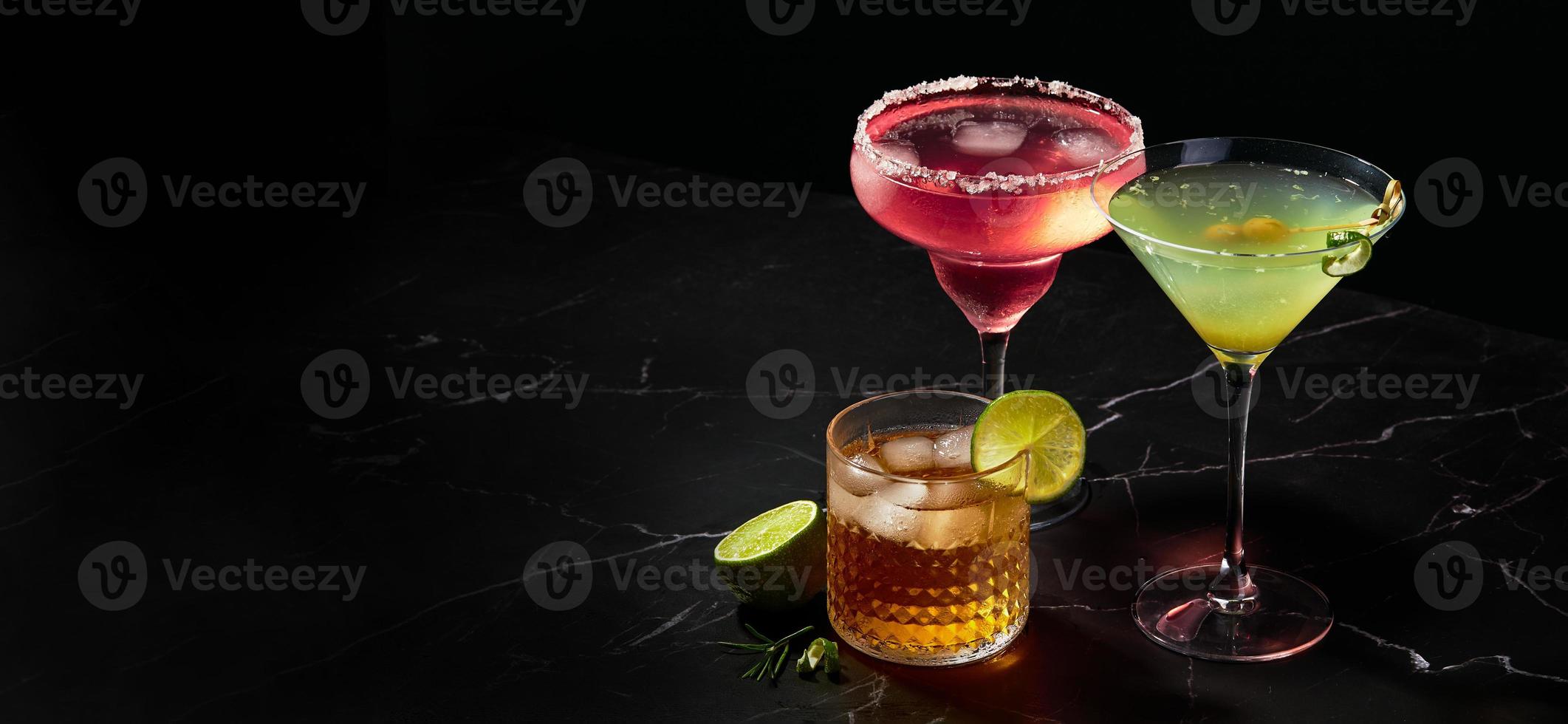 Alcoholic and non-alcoholic cocktails on dark marble table. Summer refreshments photo