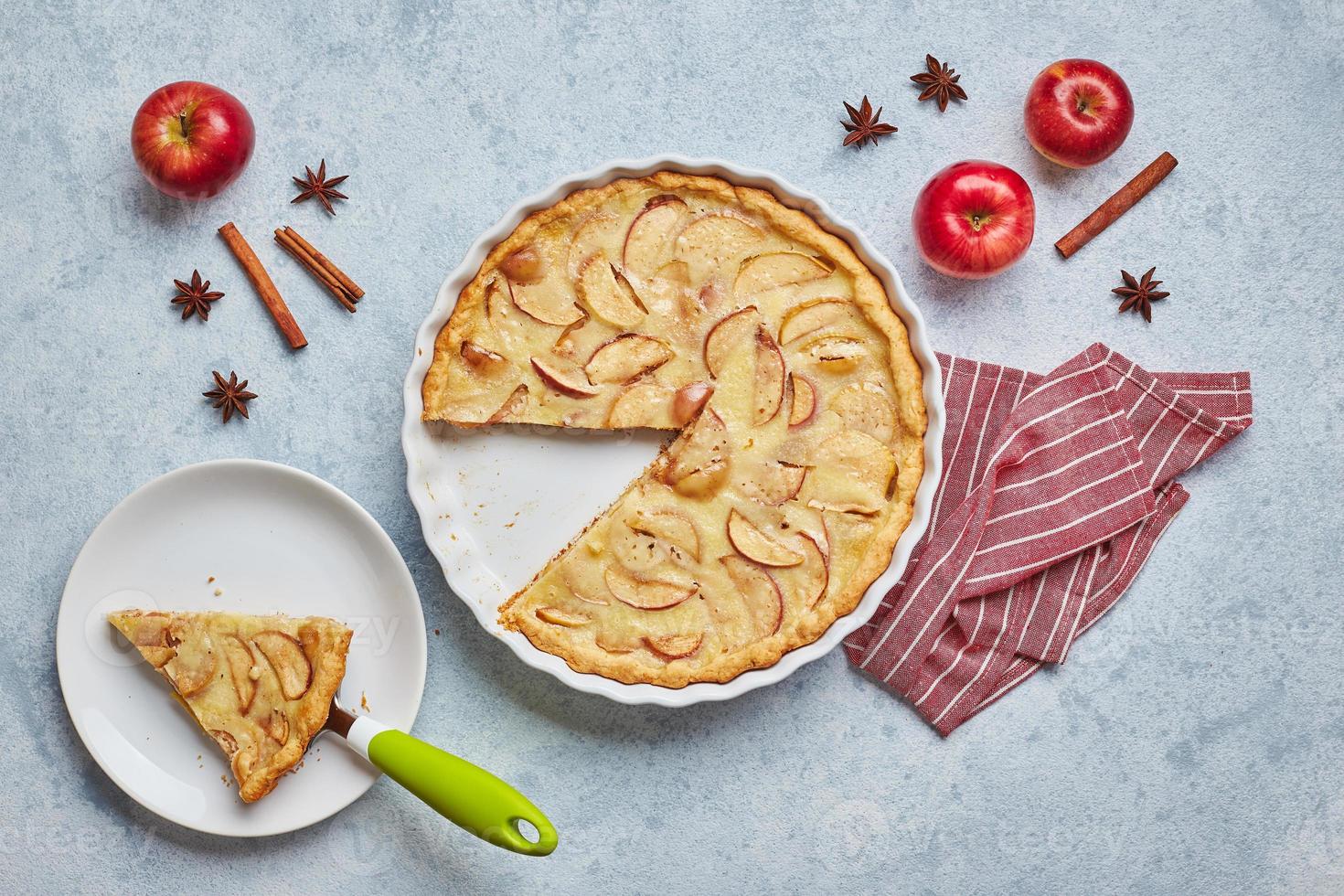 Homemade apple pie with sour cream filling on light background, top view. photo