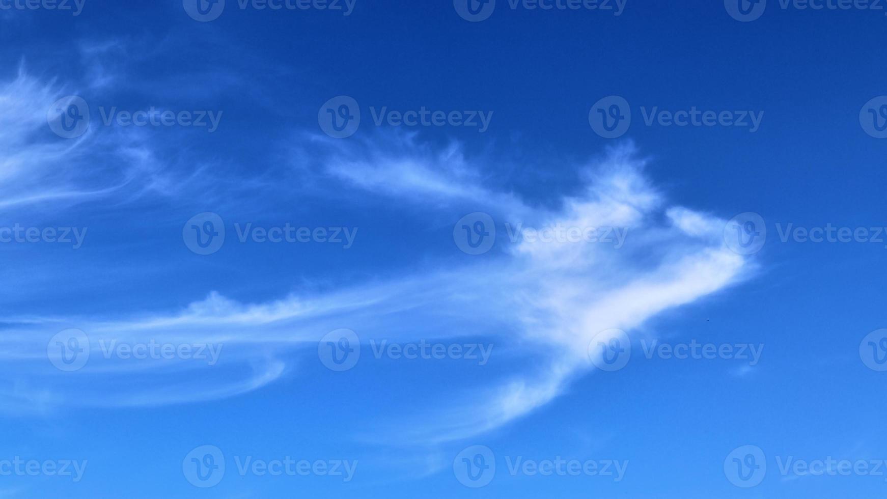 Stunning cirrus cloud formation panorama in a deep blue sky photo