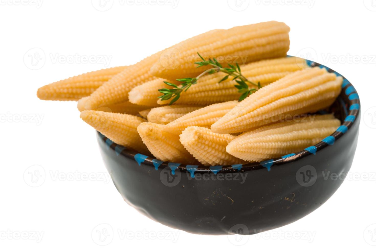 Baby corn in a bowl on white background photo