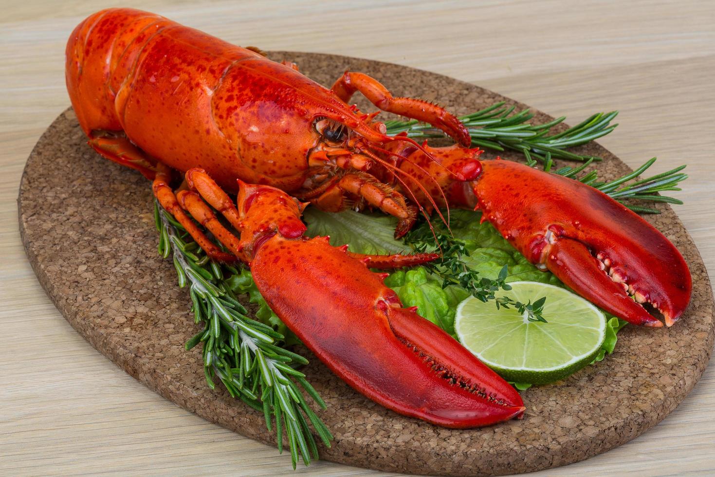 Boiled lobster on wooden board and wooden background photo