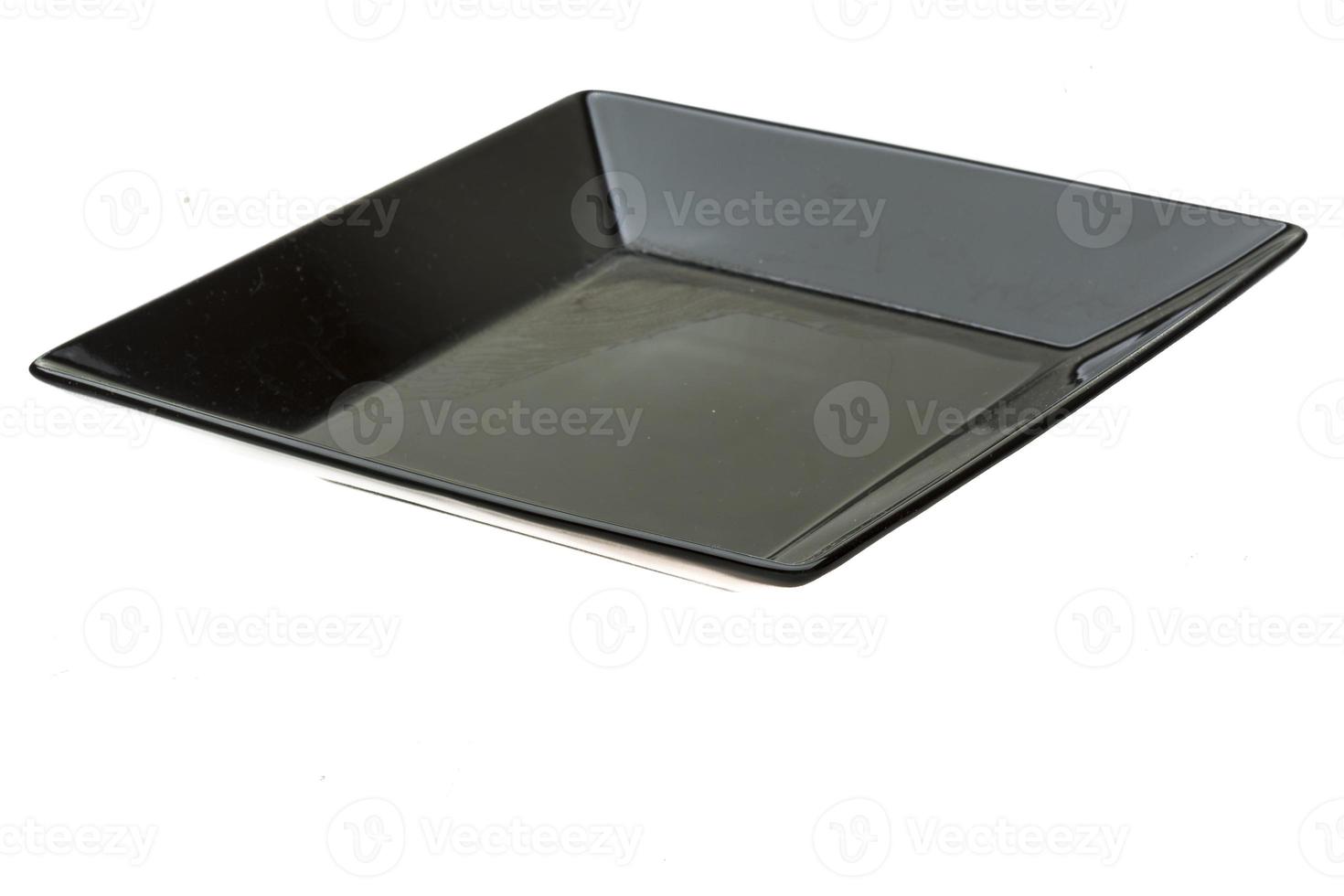 Black plate on white background photo