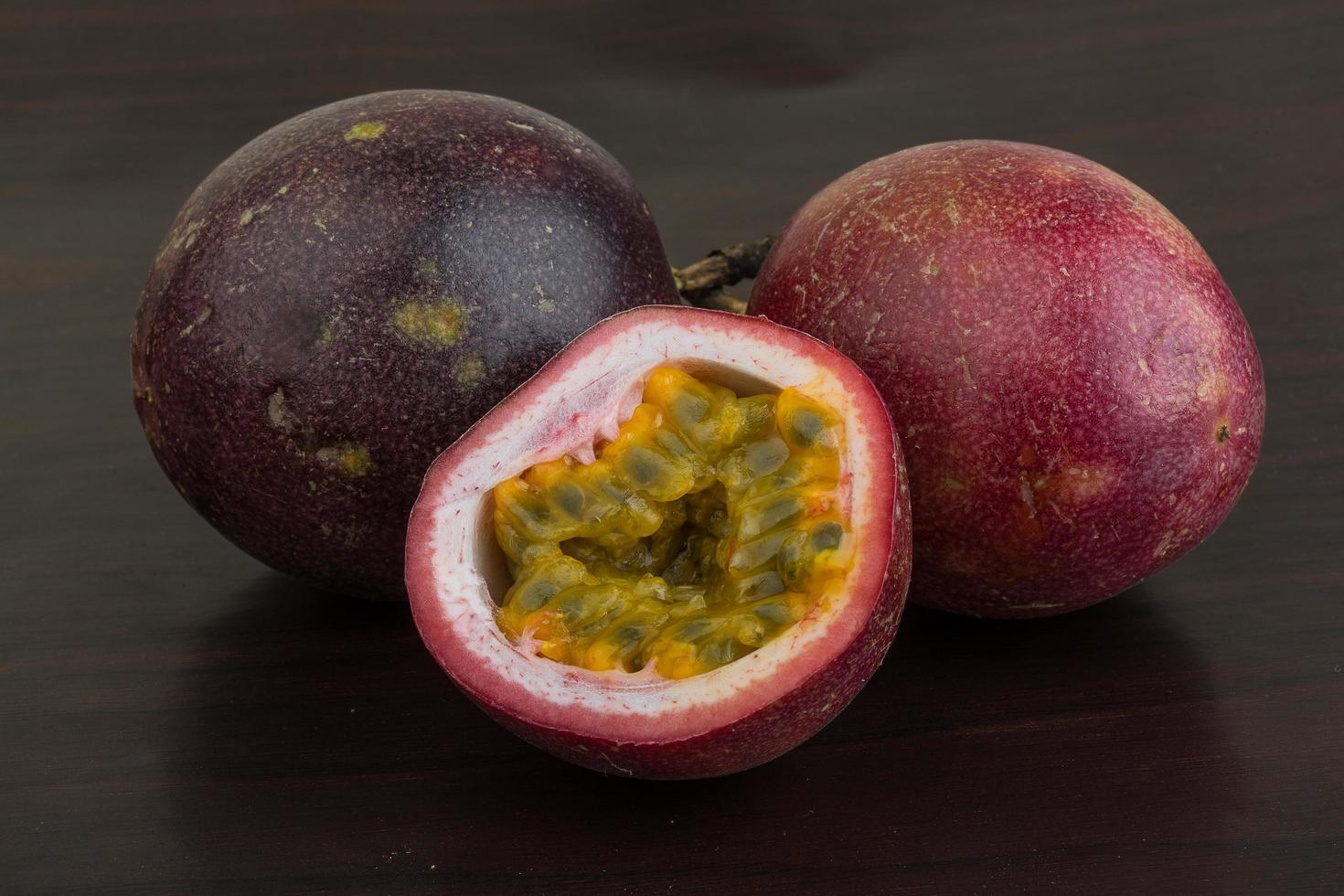 Passion fruit on wooden background photo