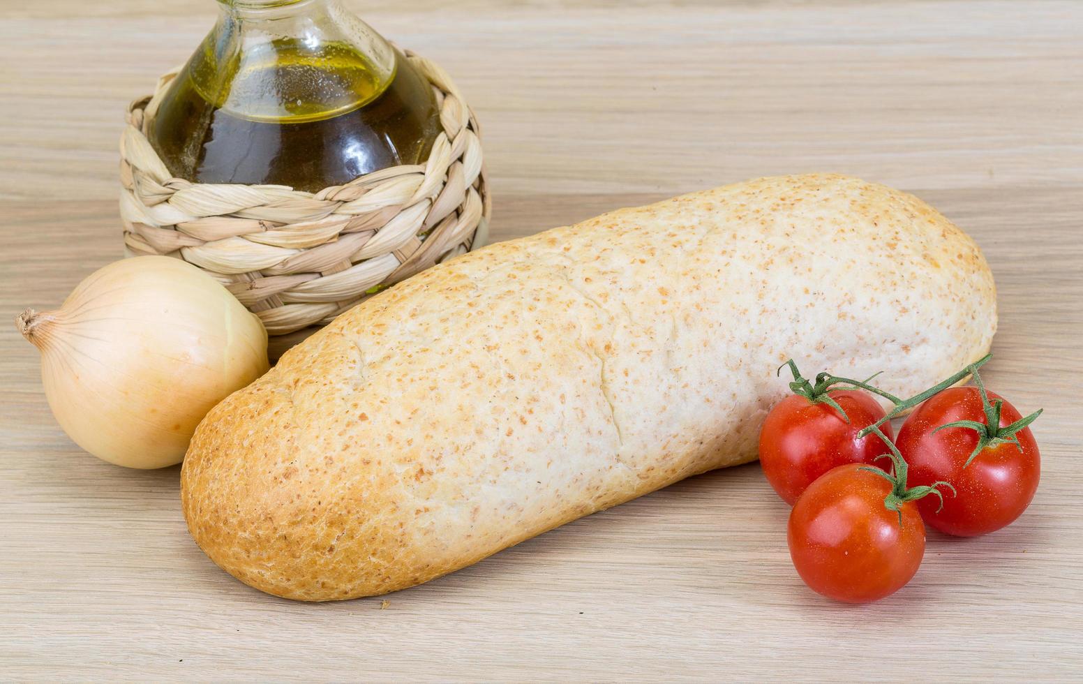 Fresh baguette on wooden background photo
