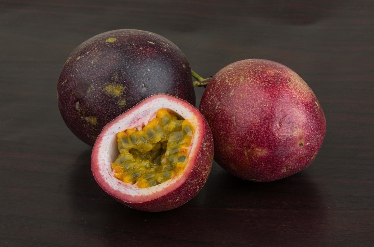 Passion fruit on wooden background photo