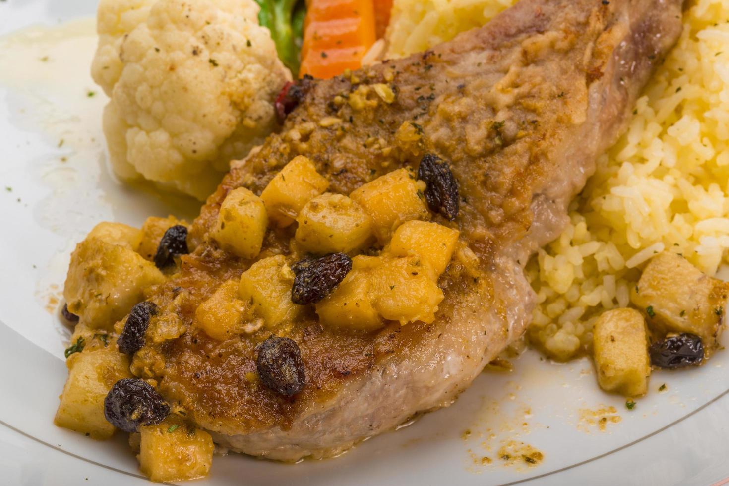 Pork t-bone steak on the plate and white background photo