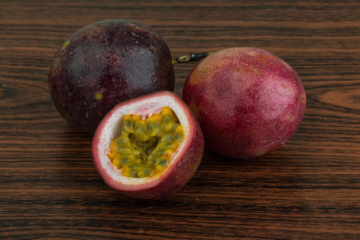 Passion fruit on wooden background photo