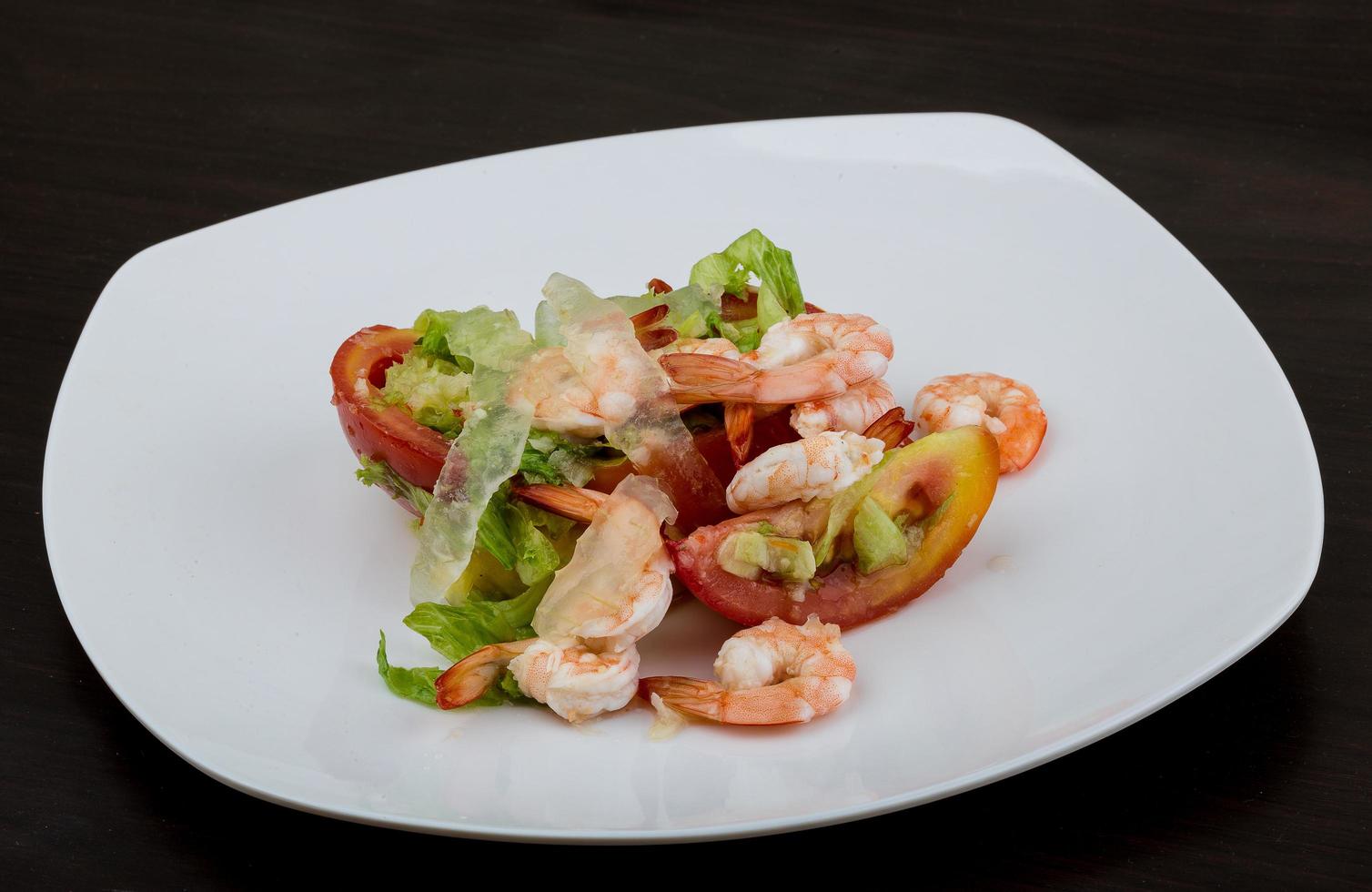 Shrimps with aloe vera salad on the plate and wooden background photo