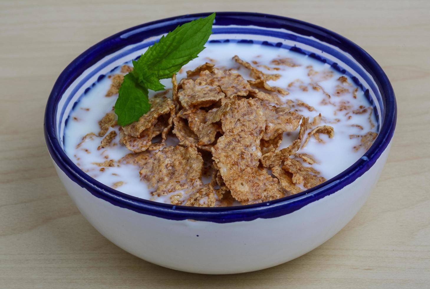 Cornfalkes breakfast in a bowl on wooden background photo