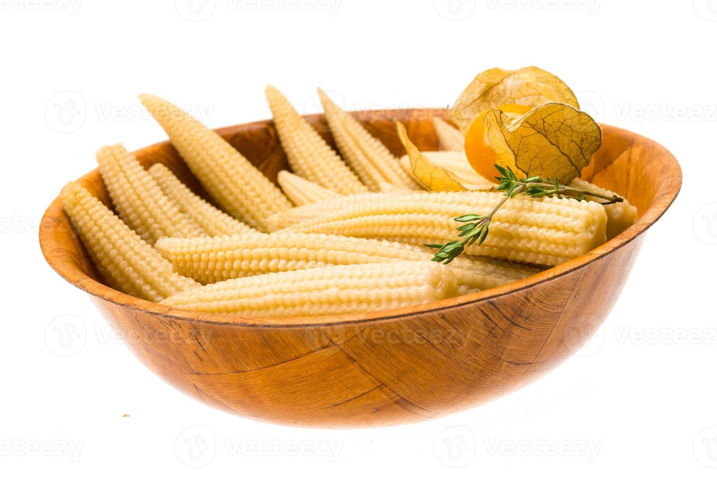 Baby corn in a bowl on white background photo