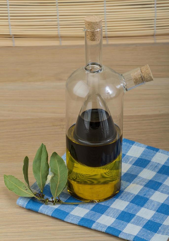 Vinegar and olive oil on wooden background photo