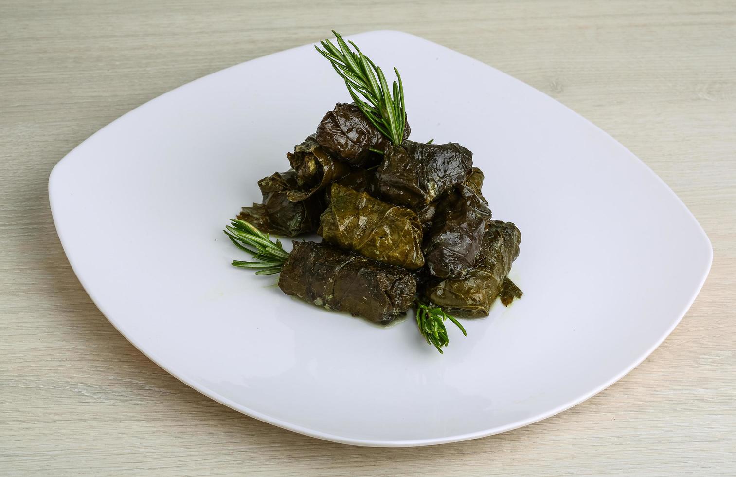 Dolma on the plate and wooden background photo