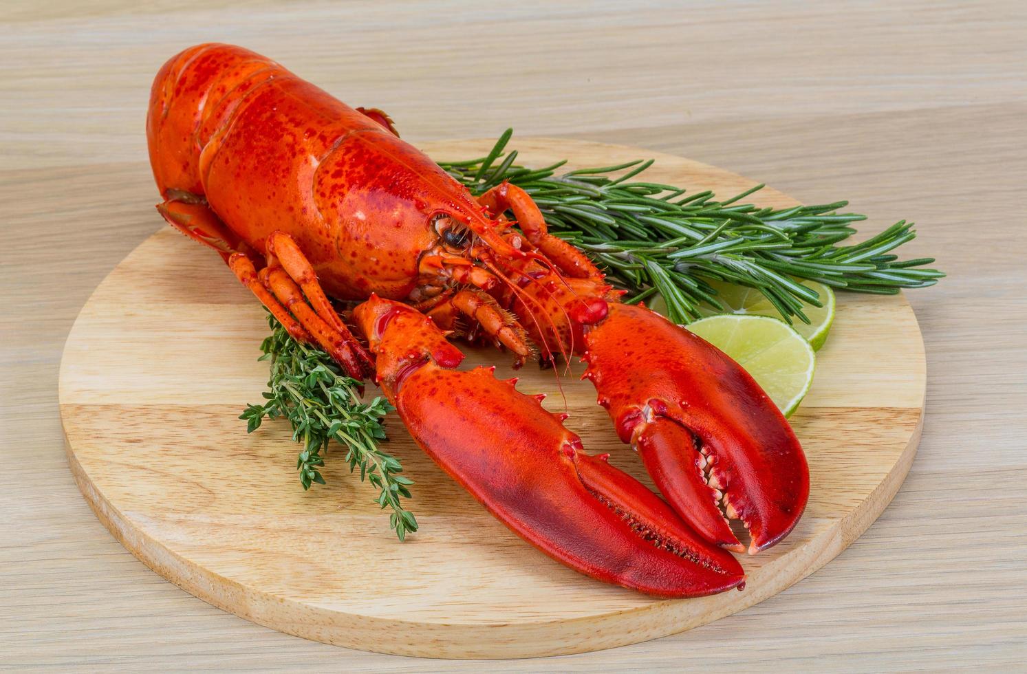 Boiled lobster on wooden board and wooden background photo