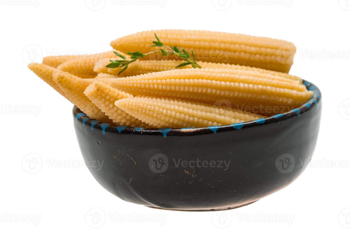 Baby corn in a bowl on white background photo