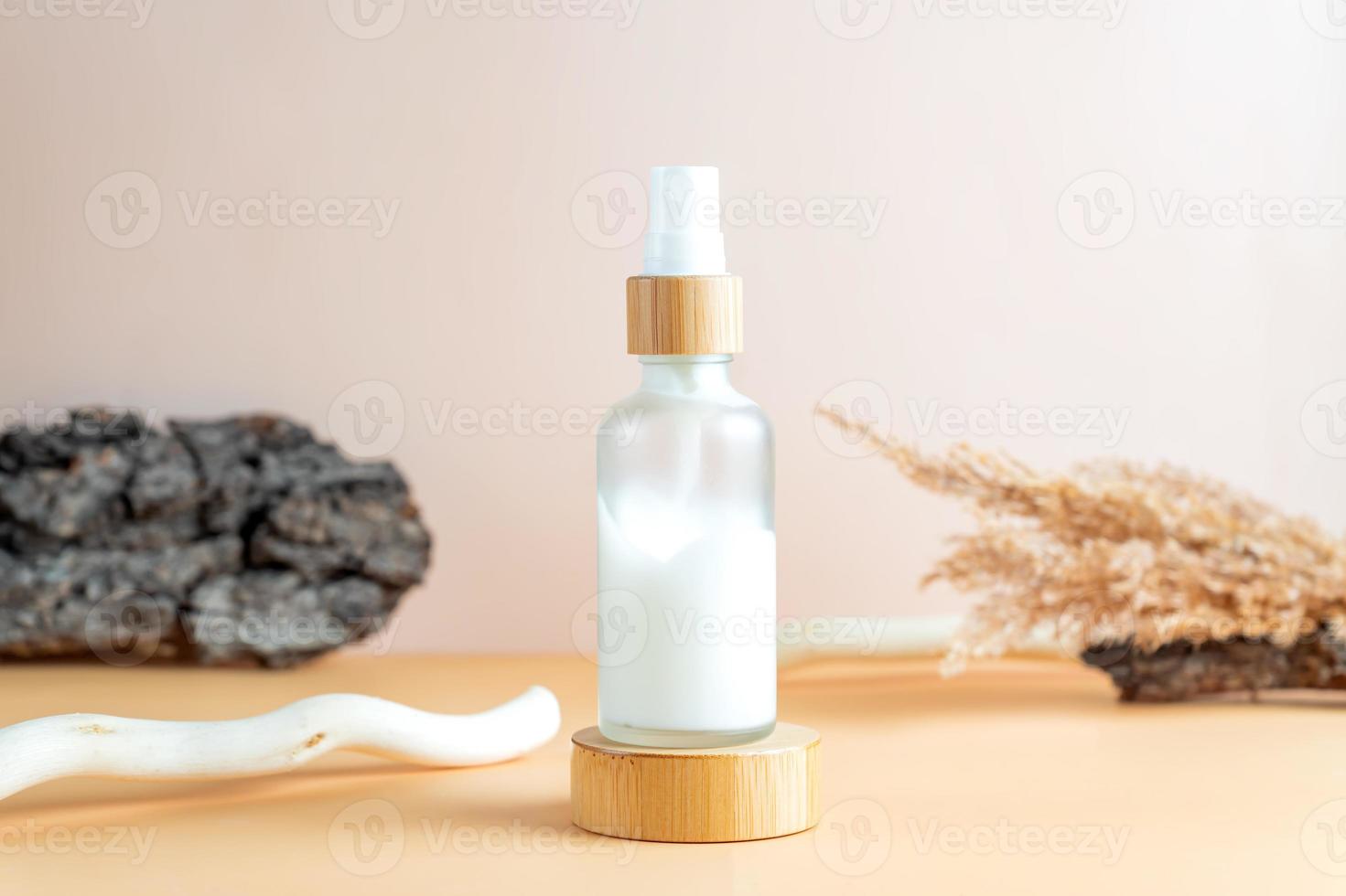 White frosted glass cosmetic cream bottle with bark of the tree, wood branch. SPA natural organic beauty product packaging design photo