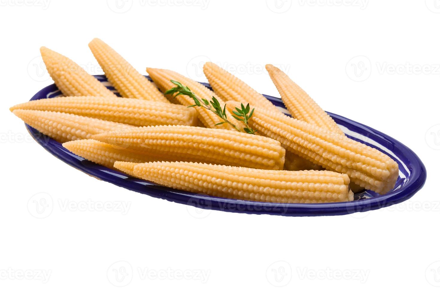 Baby corn in a bowl on white background photo