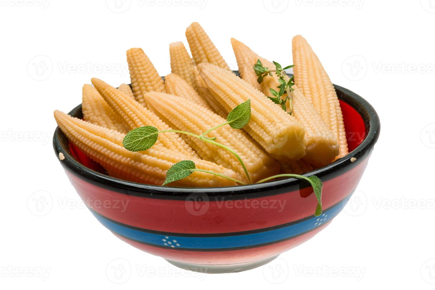 Baby corn in a bowl on white background photo